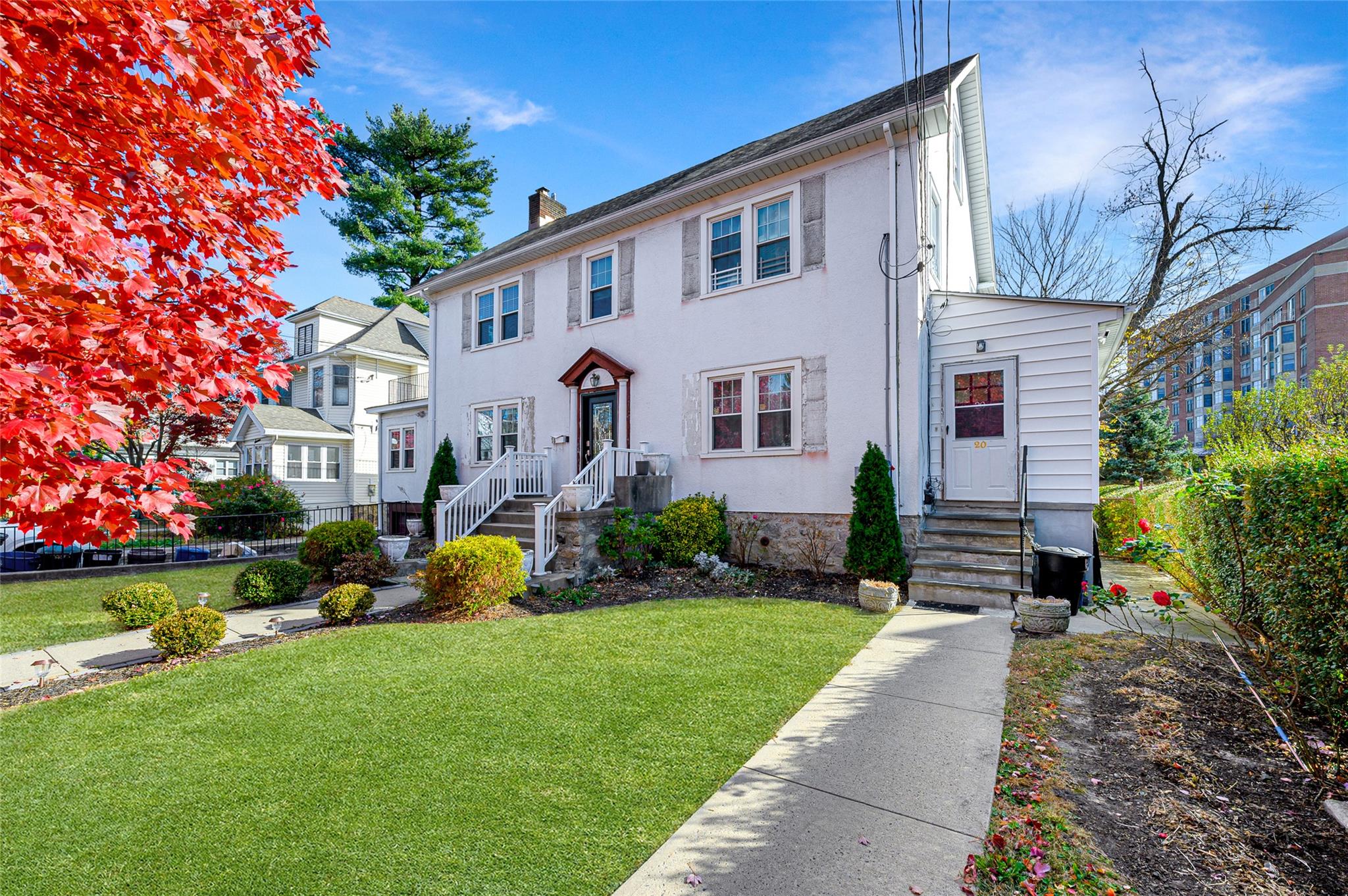 a front view of house with yard and green space