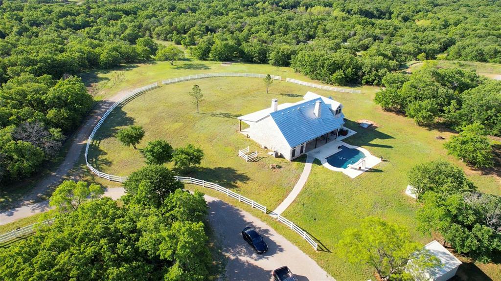 an aerial view of a house with a swimming pool