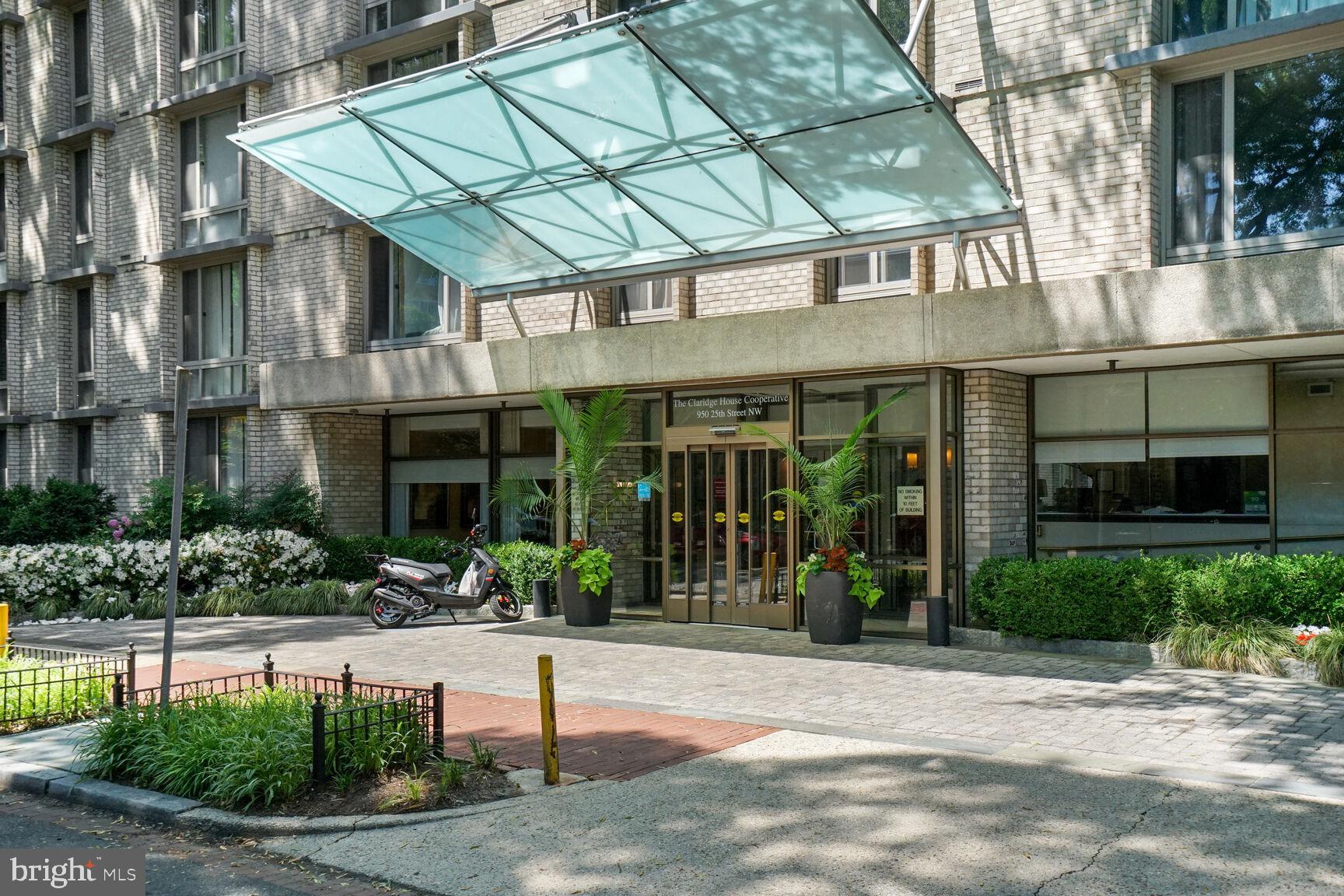 a view of a brick building with a bench in front of building