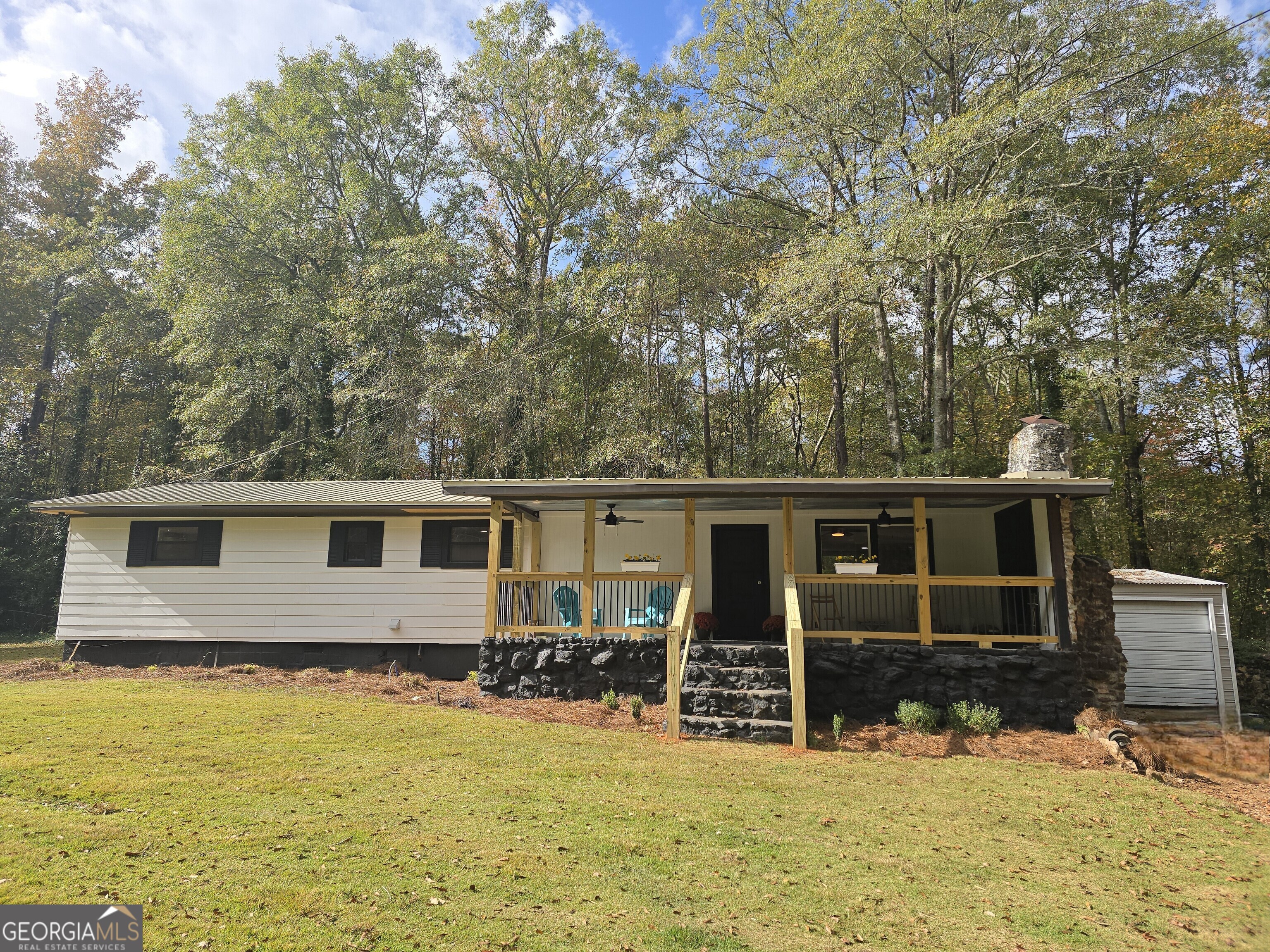 a front view of a house with yard patio and backyard