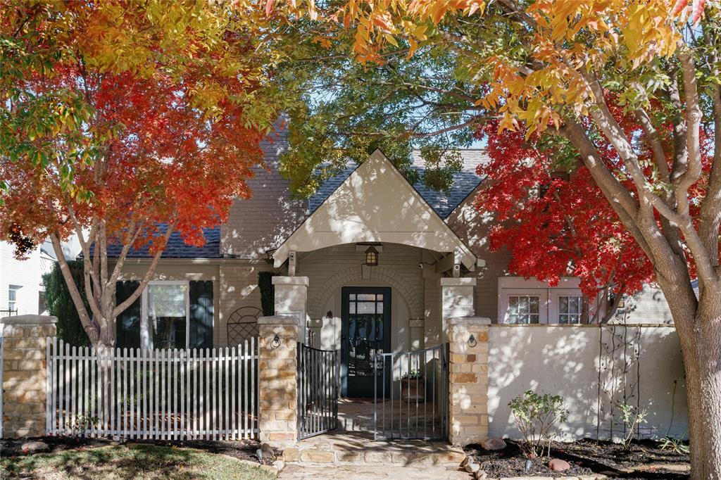 a front view of a house with a tree