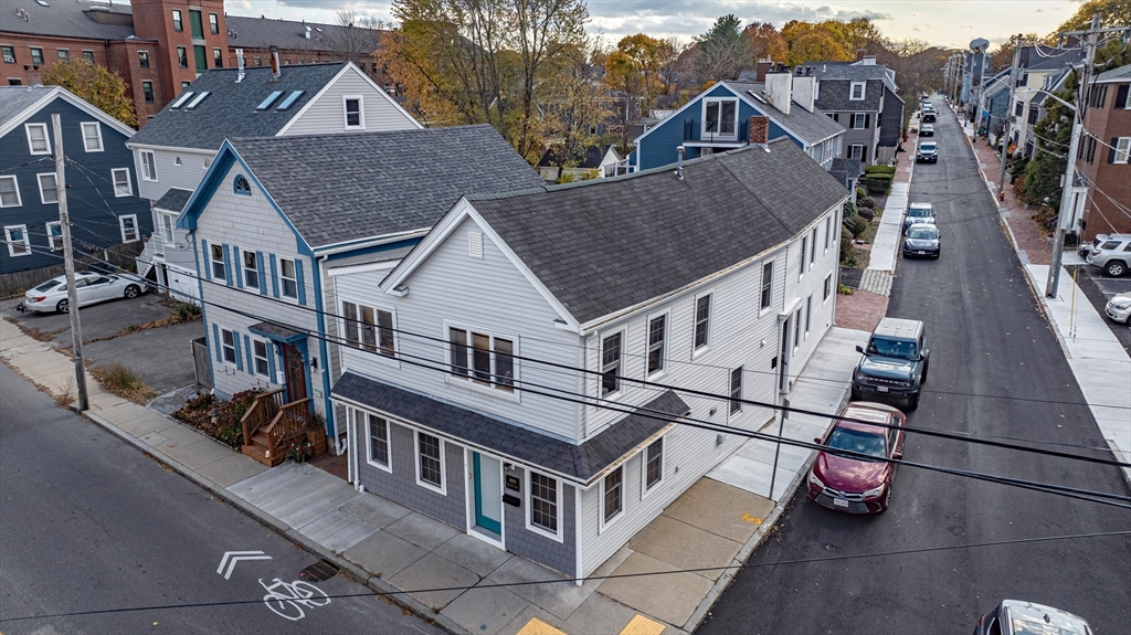 an aerial view of a house with a yard