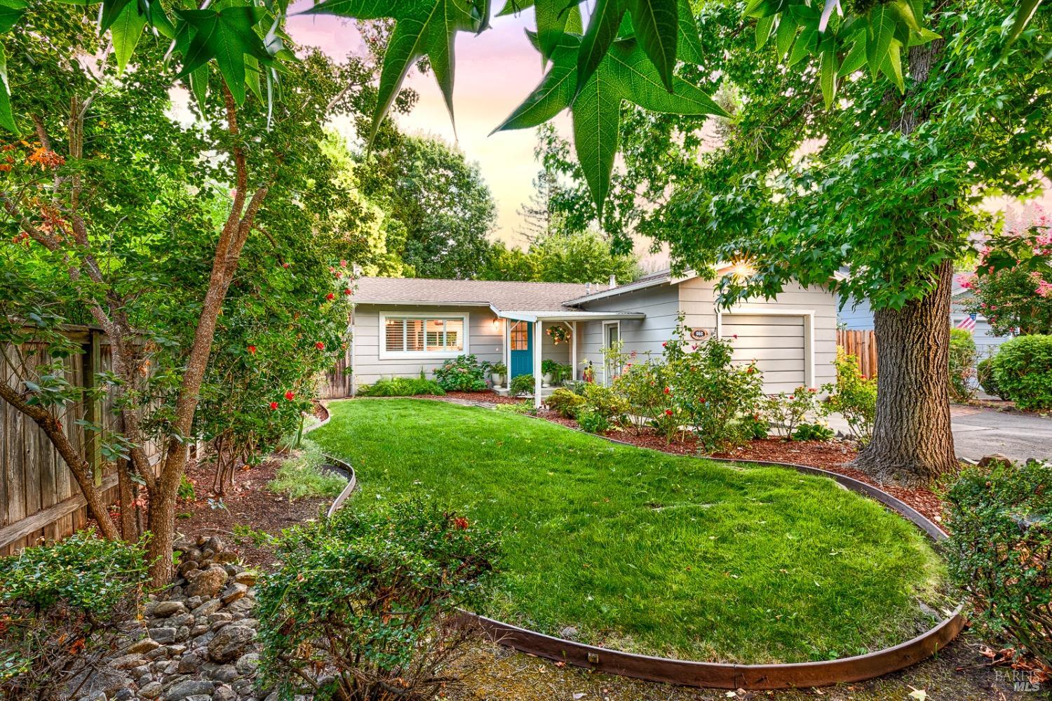 a view of a house with a backyard