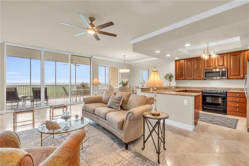 a living room with furniture kitchen and a view of kitchen