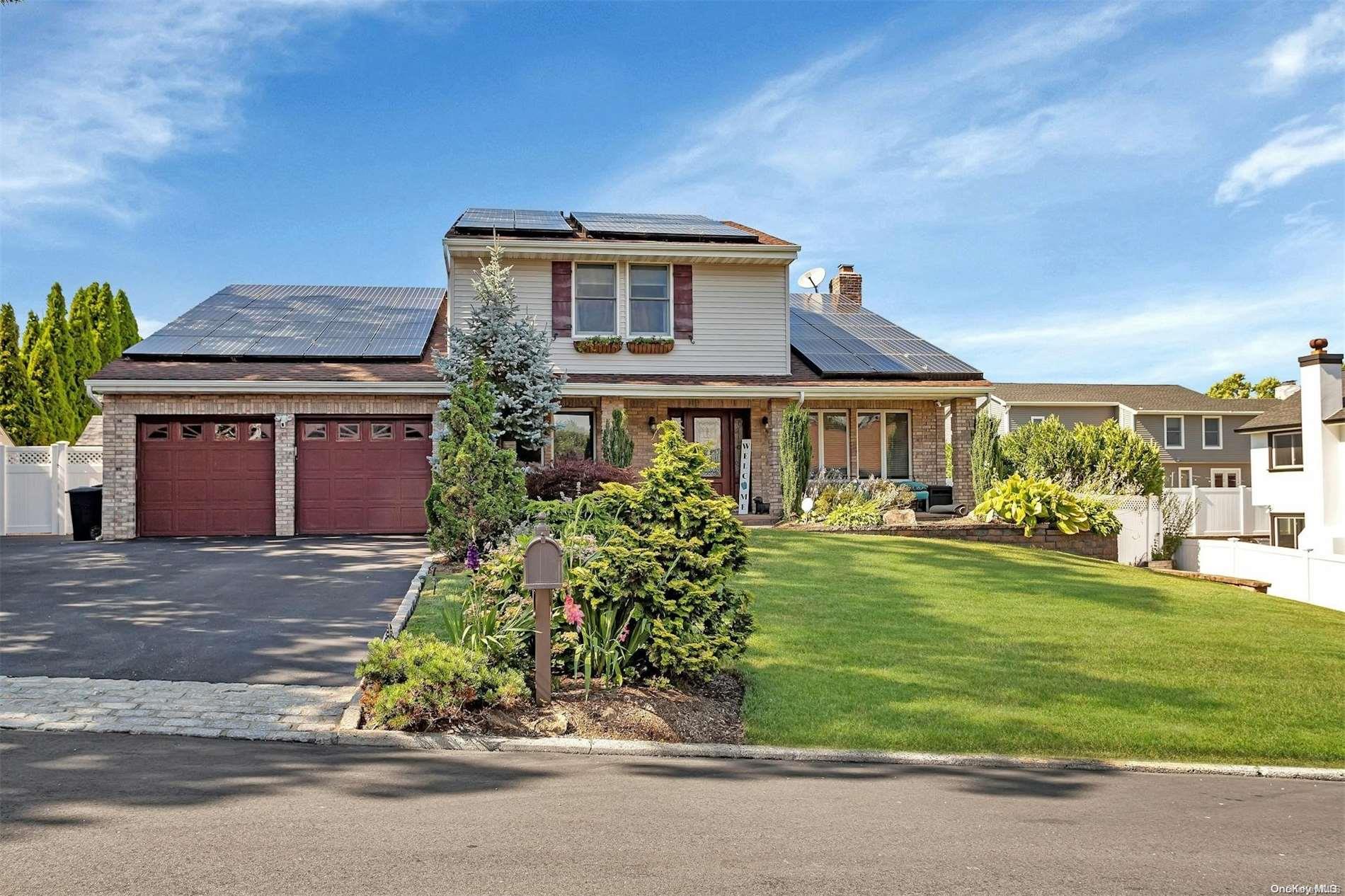 a front view of a house with a garden