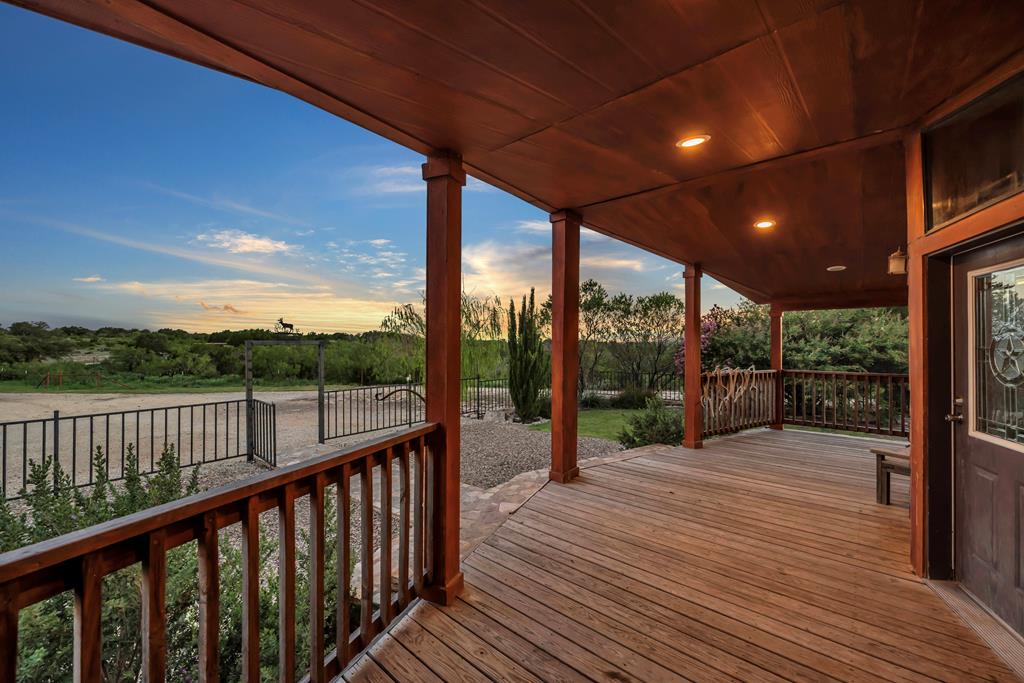 a balcony with wooden floor and fence