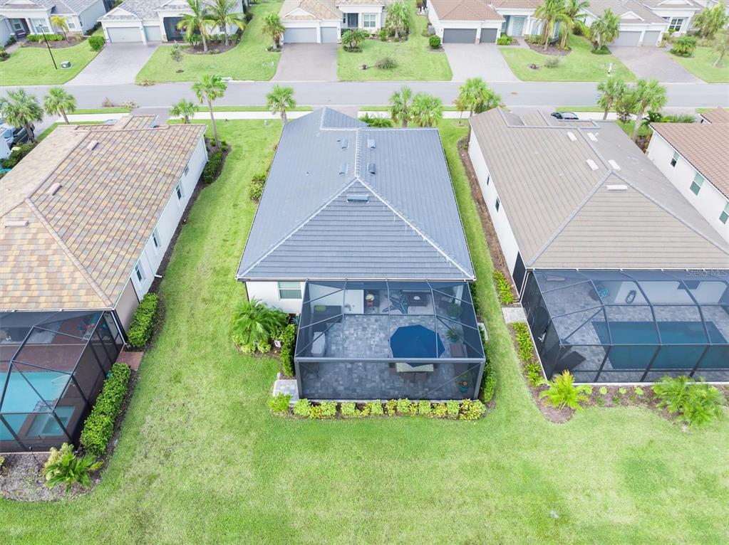 an aerial view of a house with a garden and swimming pool