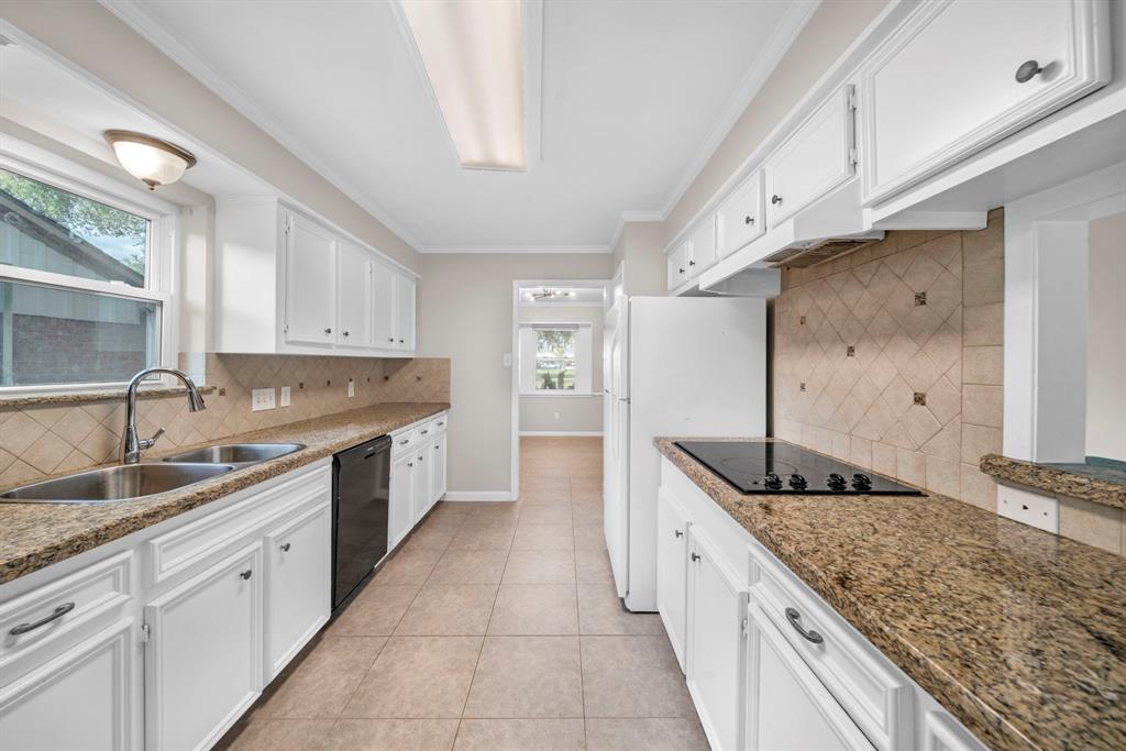 a large kitchen with granite countertop a sink and dishwasher stove top oven