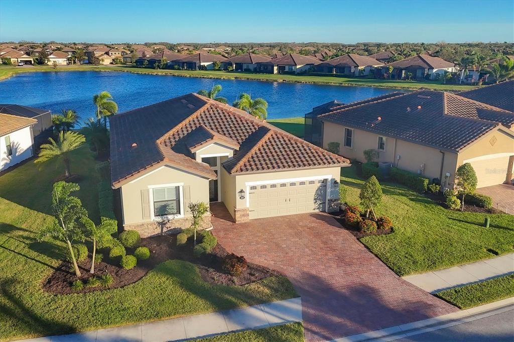 an aerial view of a house with a yard