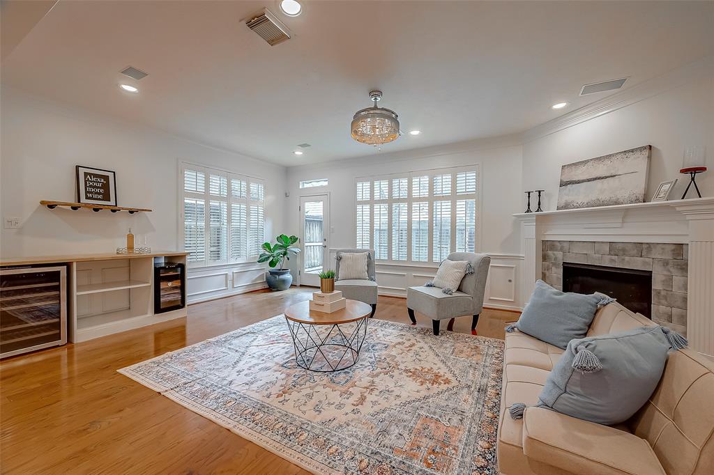 a living room with furniture wooden floor and a fireplace