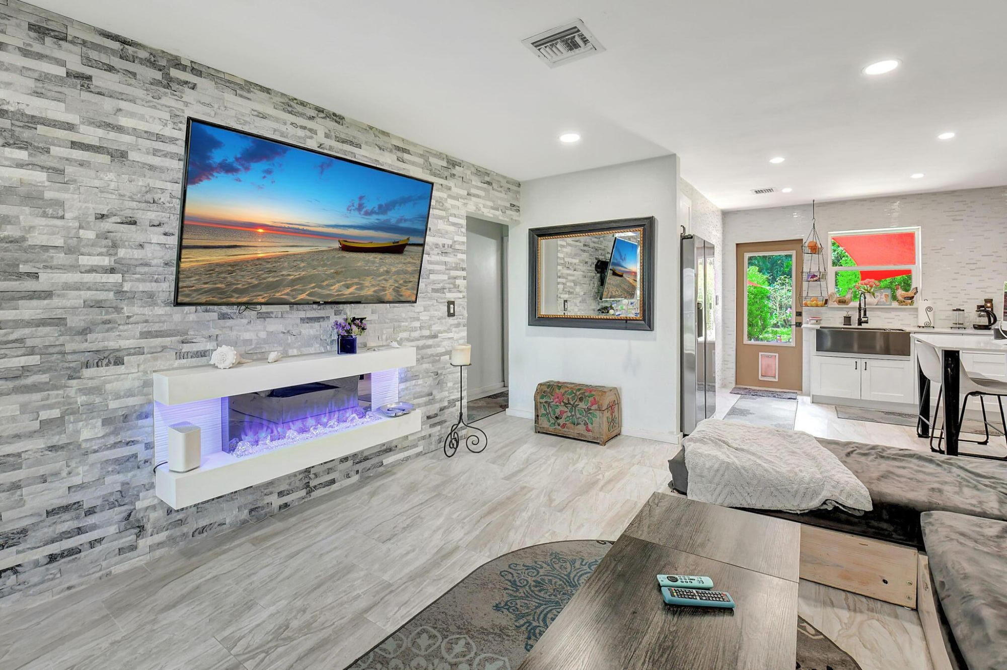 a living room with fireplace furniture and a flat screen tv