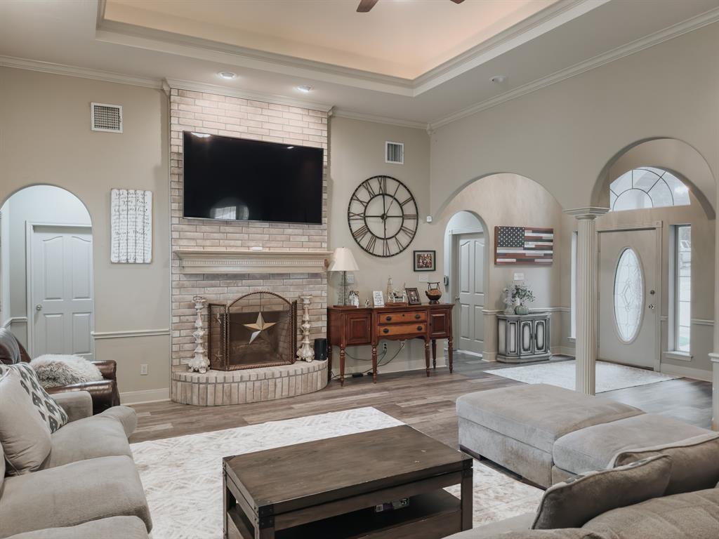 a living room with furniture a fireplace and flat screen tv