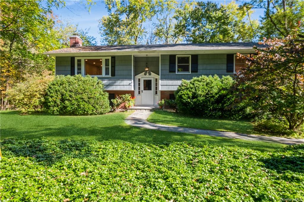 a view of a house with a yard and a garden