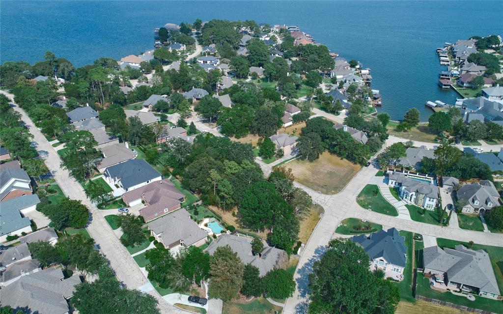 an aerial view of residential house with outdoor space and trees all around