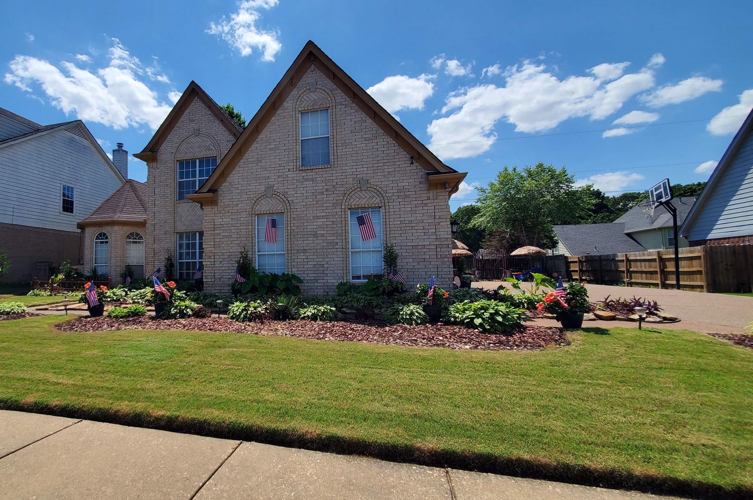 a front view of a house with a garden