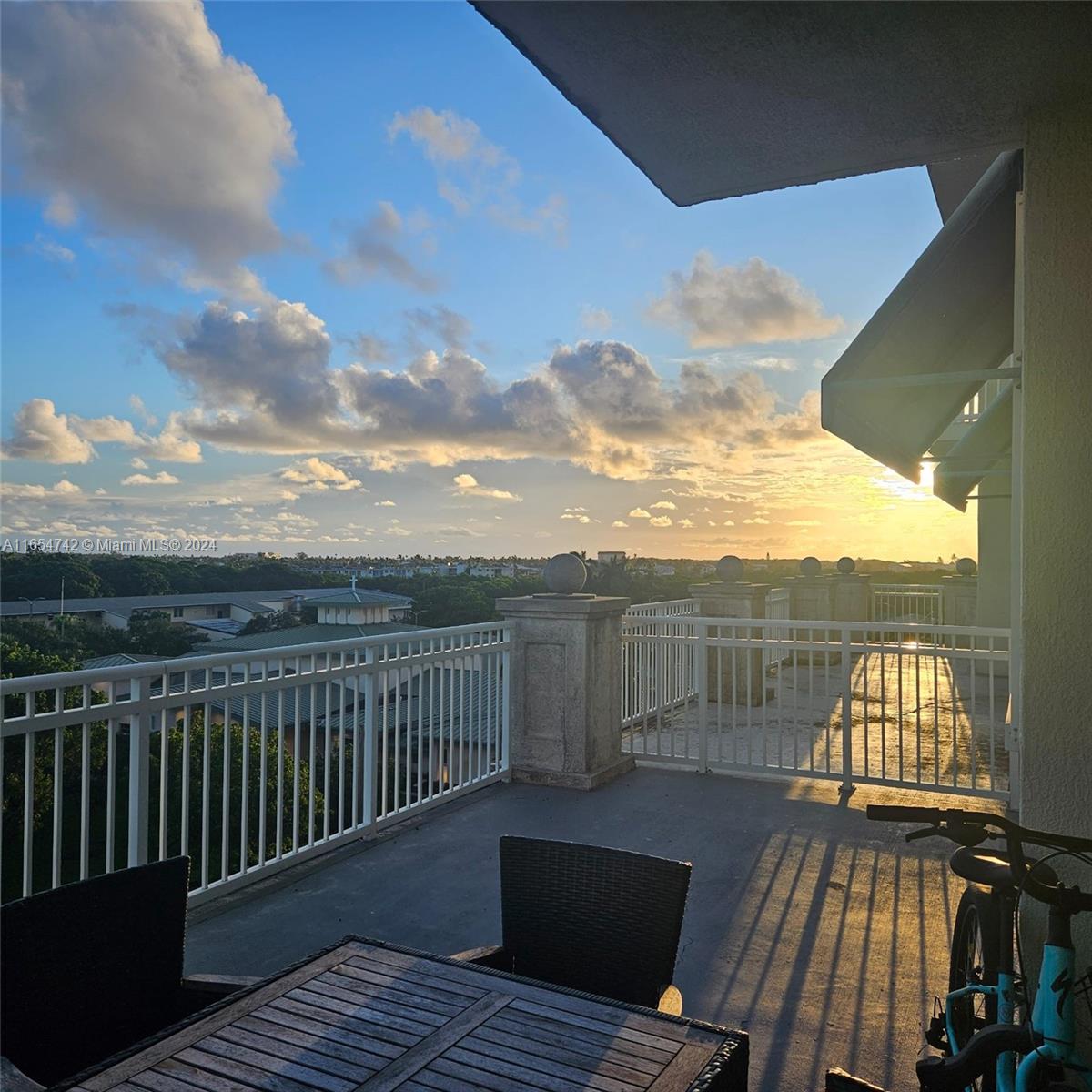 a view of balcony with wooden floor and city view