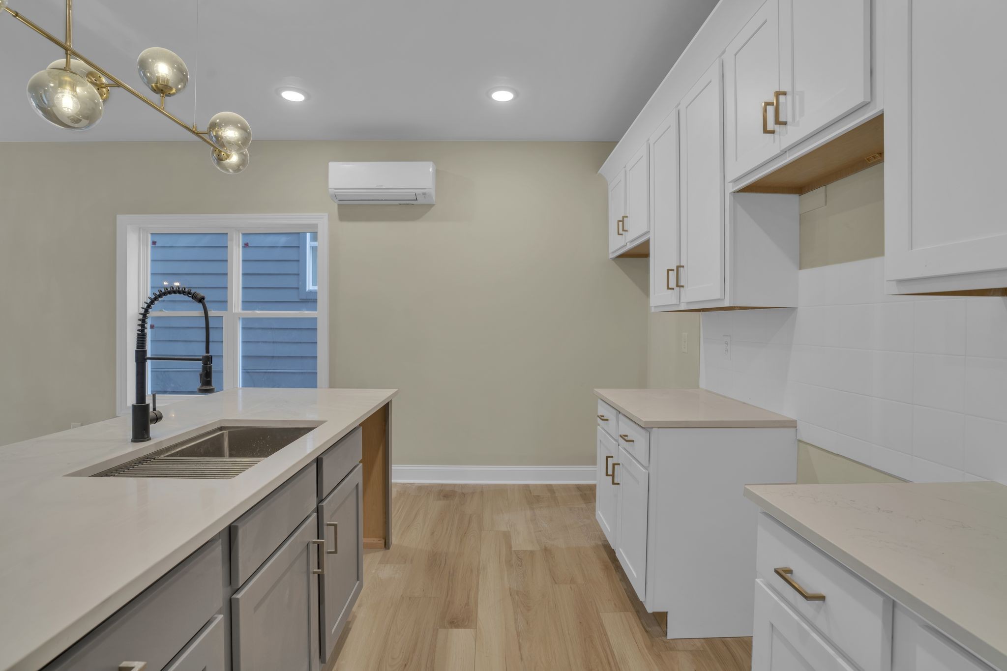 a kitchen that has a sink and a stove in it