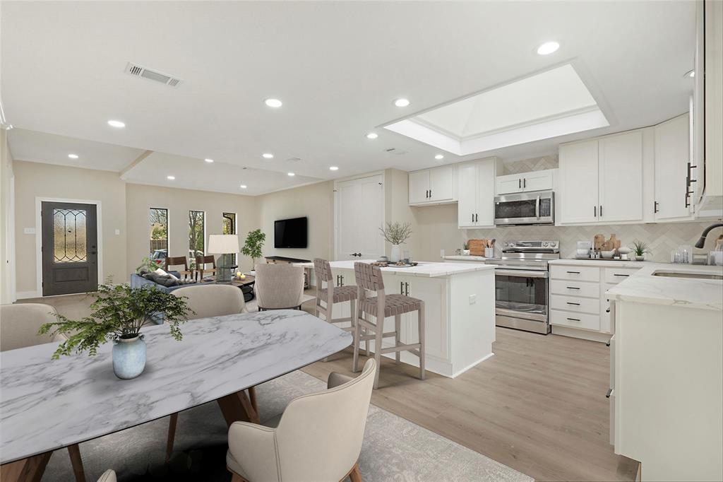 a kitchen with microwave a refrigerator and chairs