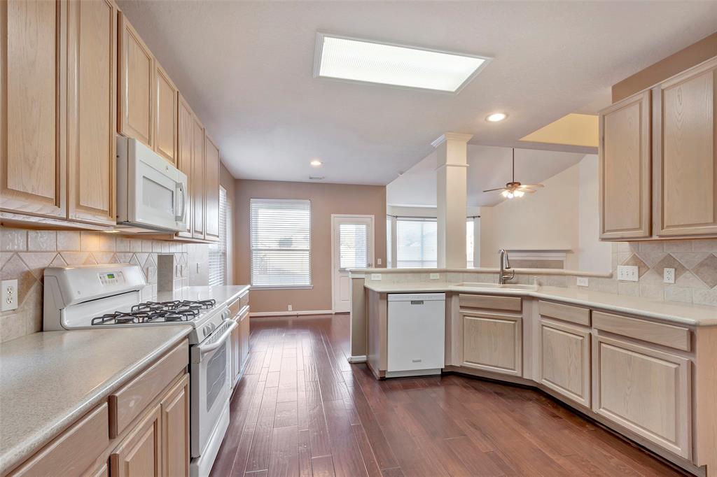 a large kitchen with stainless steel appliances a lot of counter space and a sink