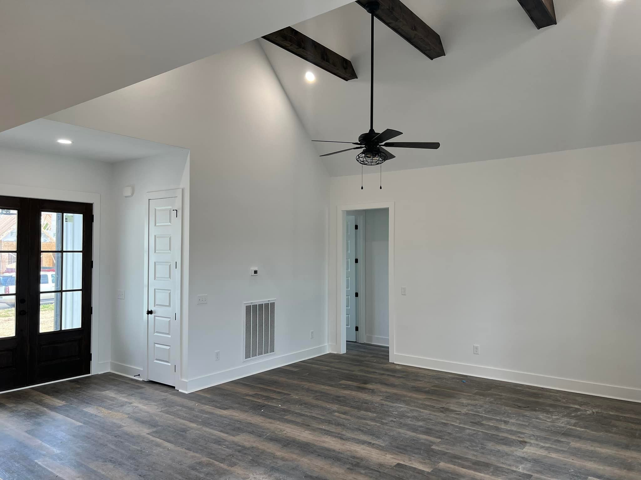 wooden floor in an empty room with a window