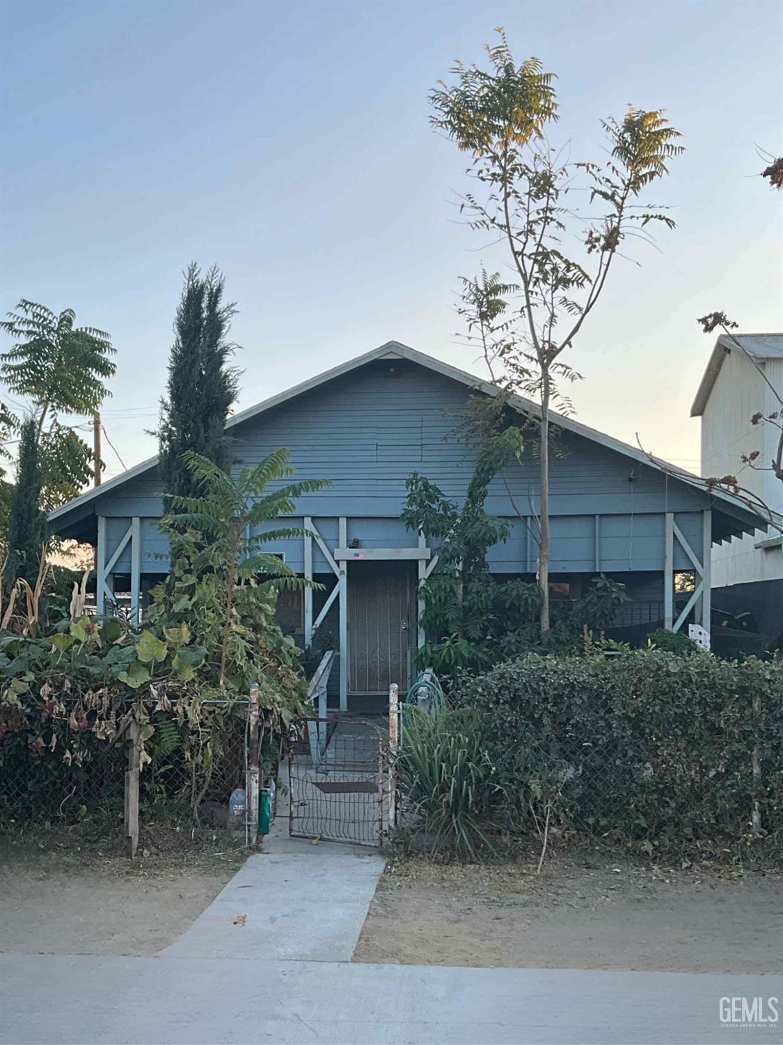 a house that has a tree in front of it