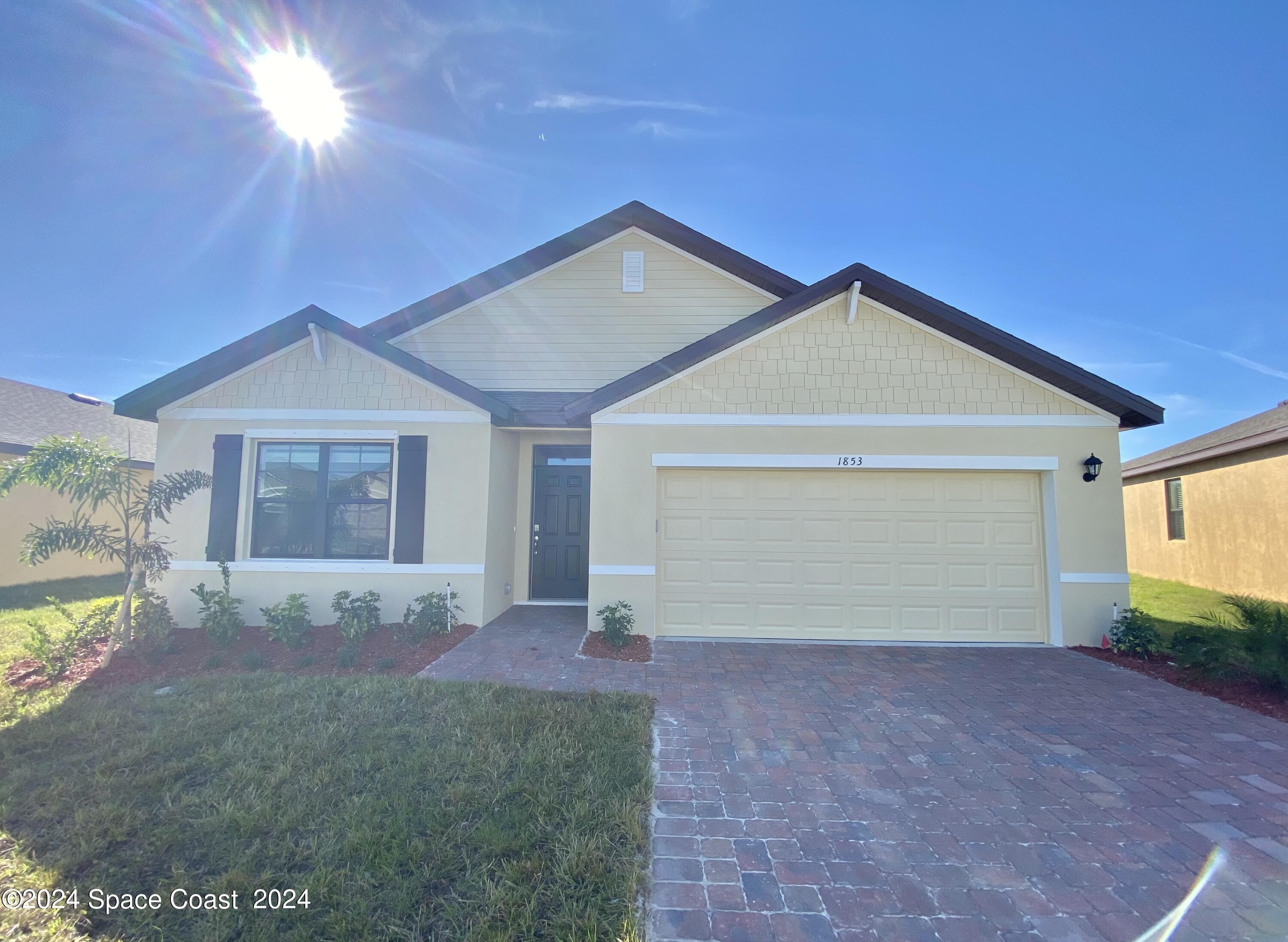 a view of a house with a yard and garage