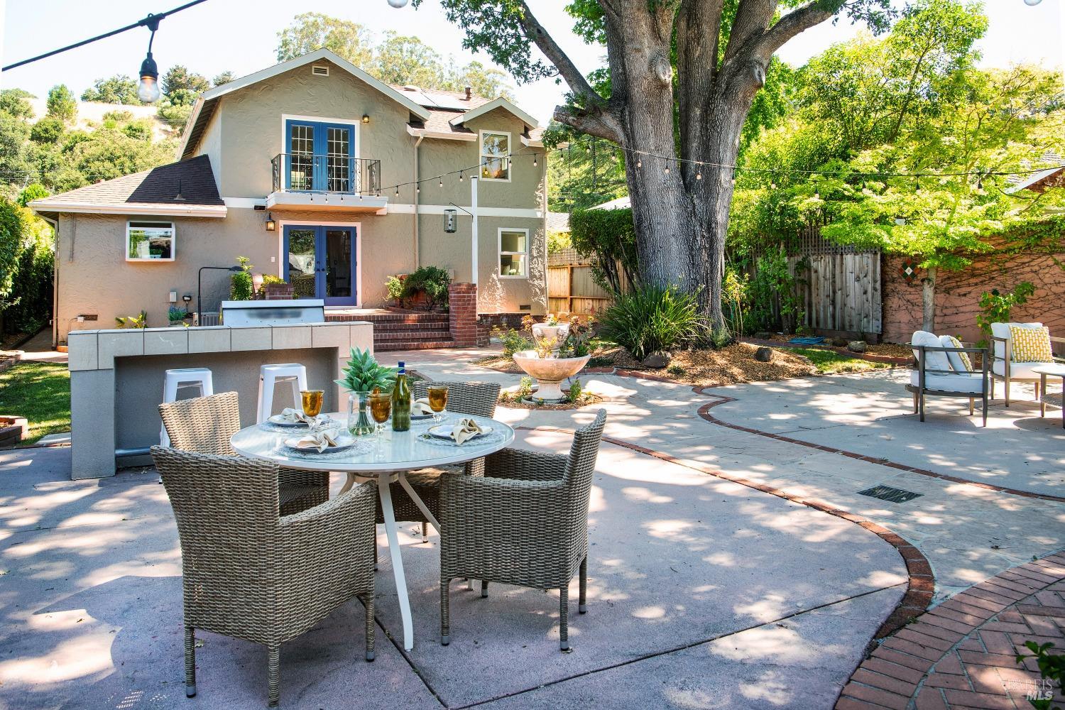 a view of a patio with table and chairs and potted plants