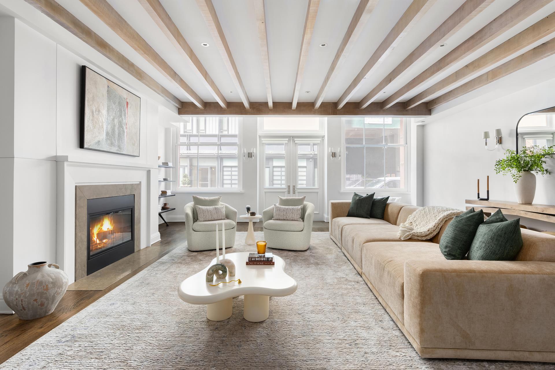 a living room with furniture a fireplace and a large window