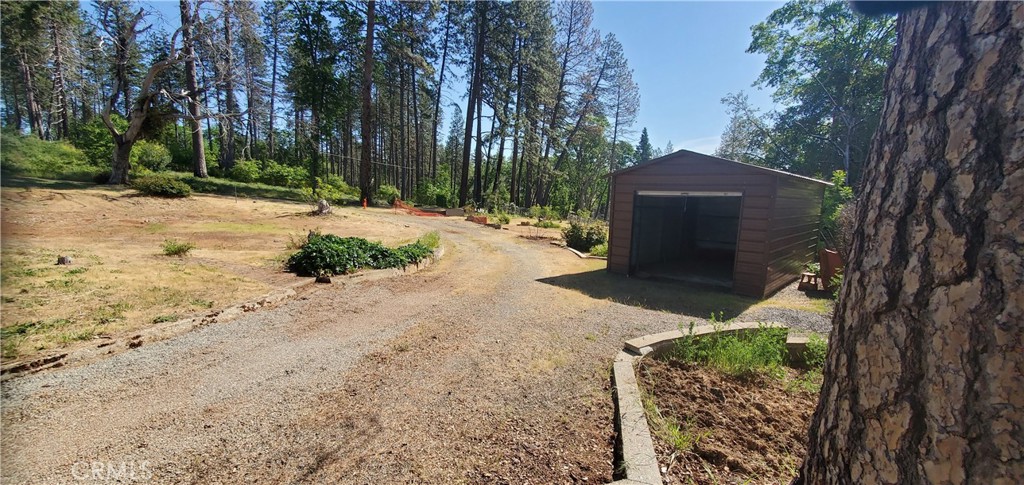 a front view of a house with a yard and tree s