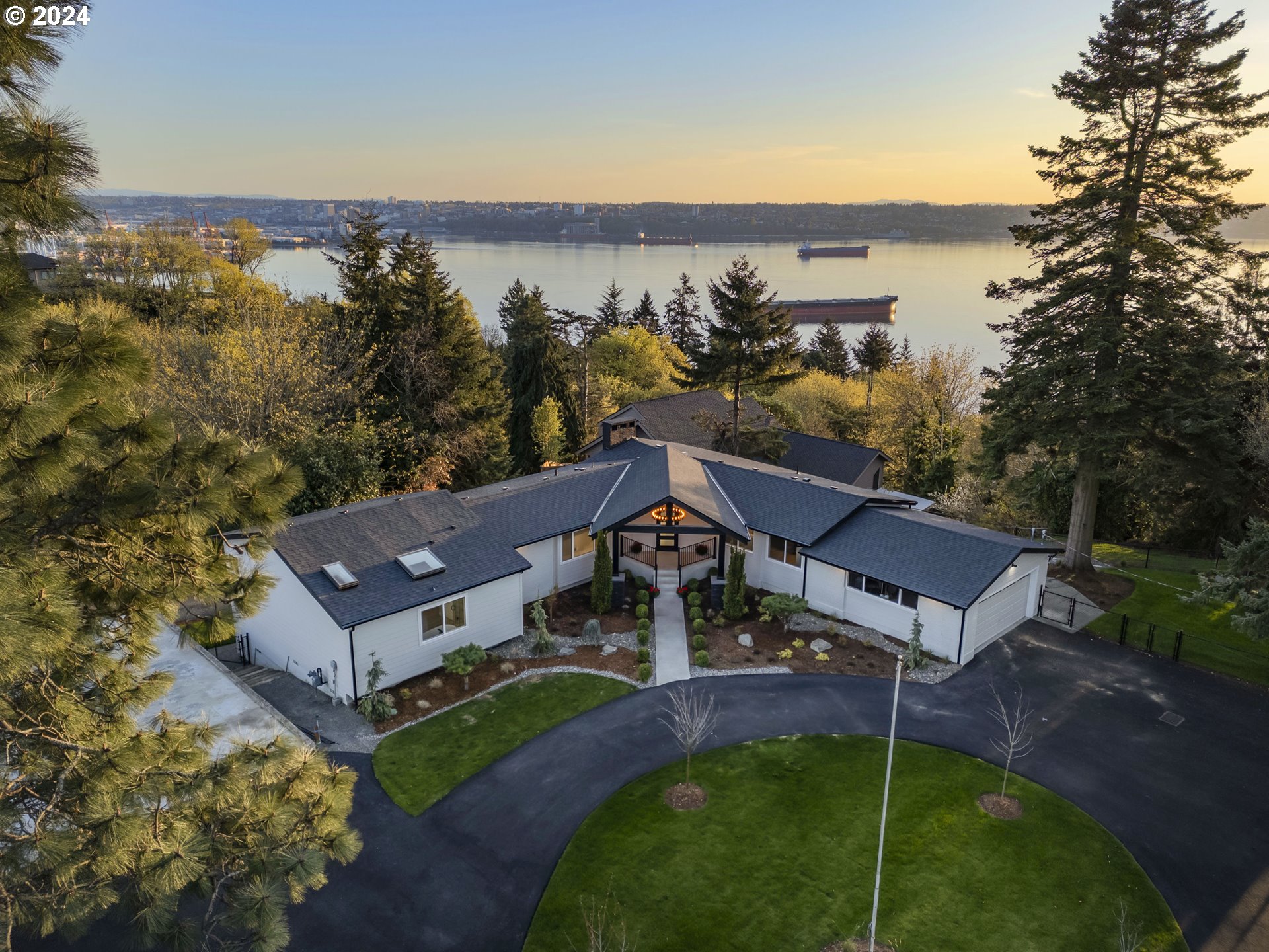 an aerial view of a house with a garden and lake view