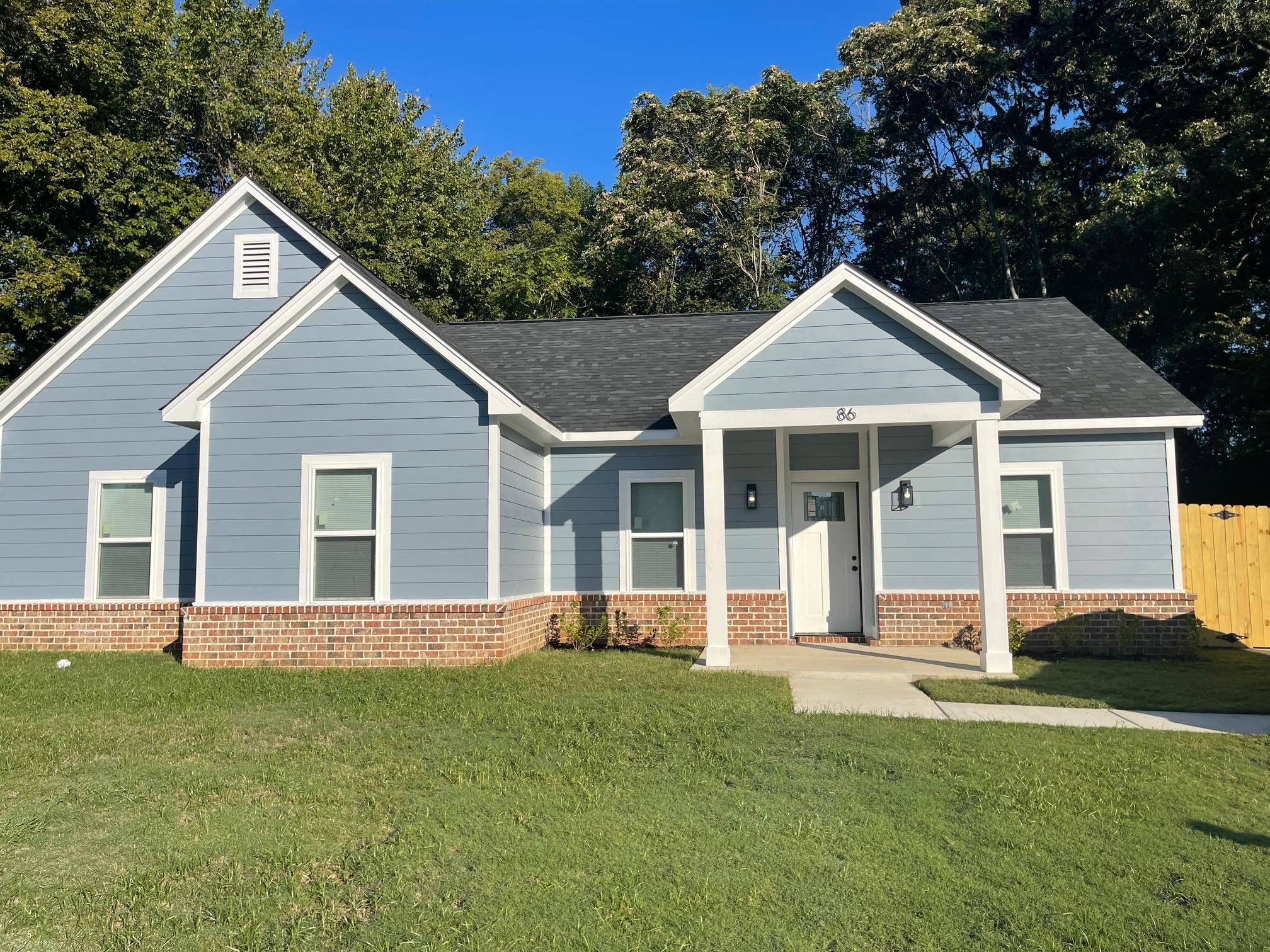 View of front of house featuring covered porch and a front yard