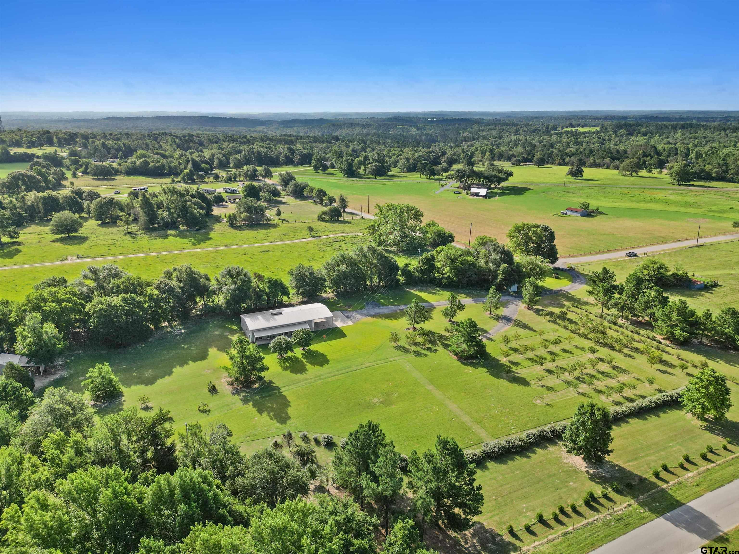 an aerial view of a houses with outdoor space and river view