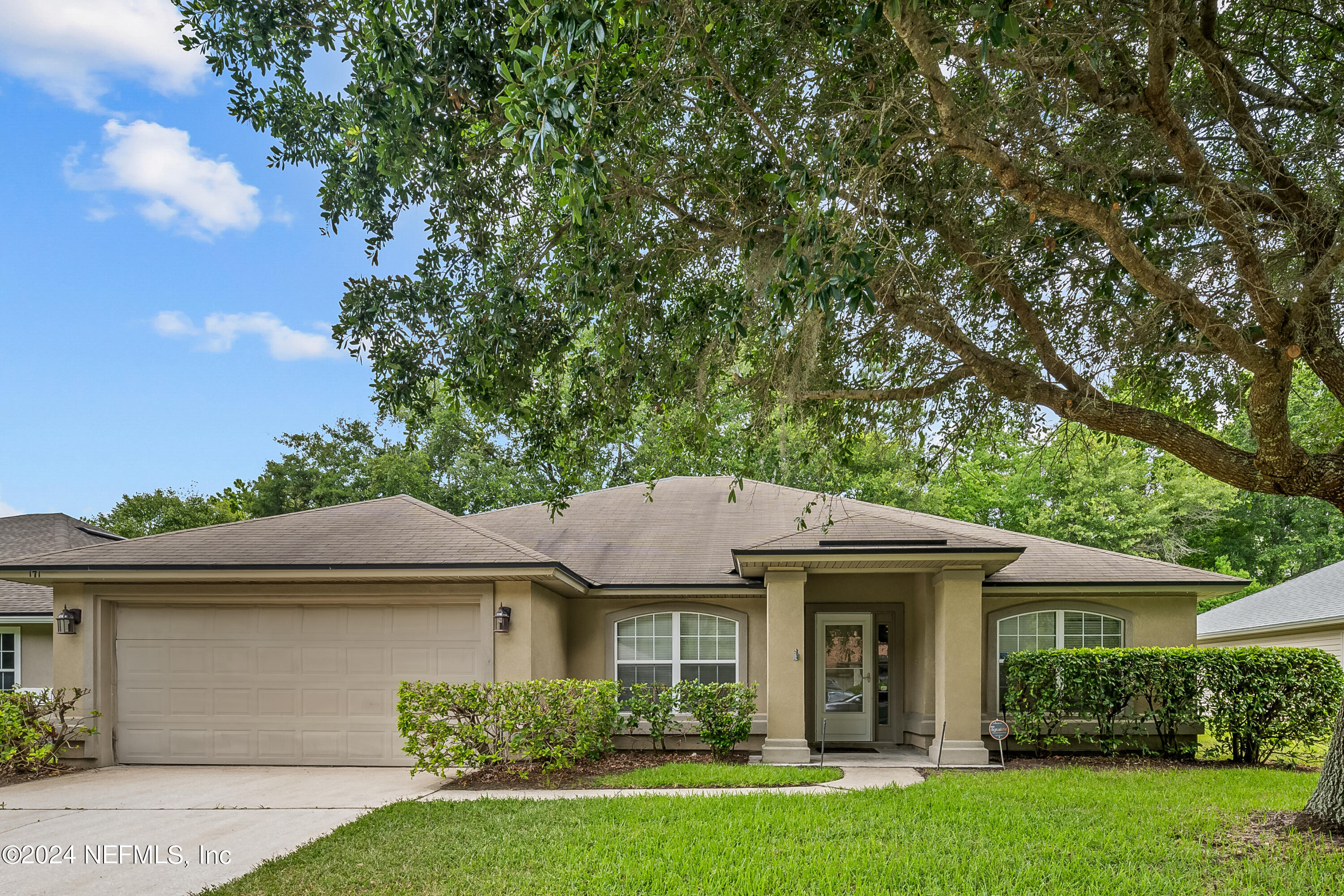 a front view of a house with a garden