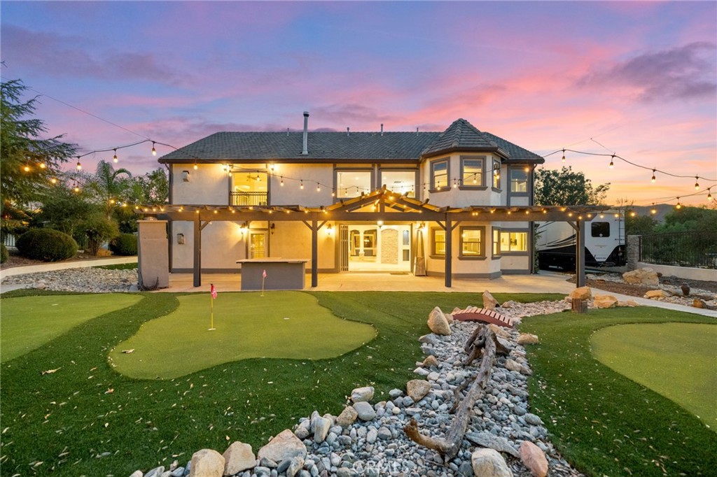 a view of an house with swimming pool and a yard