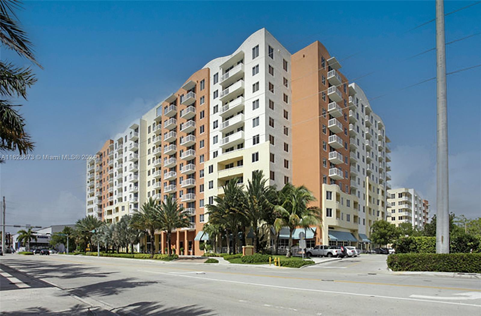 a view of a tall building next to a road