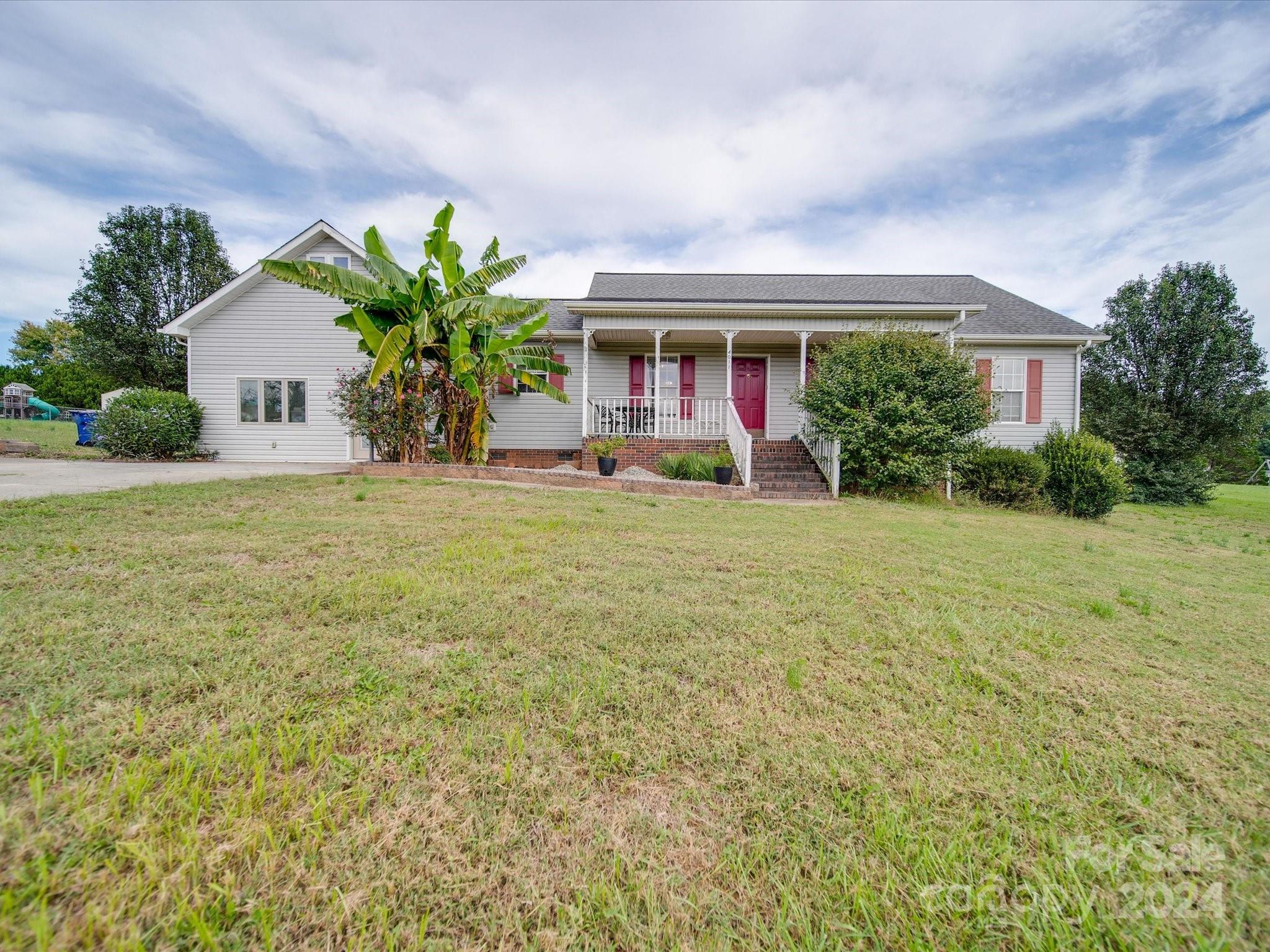 a front view of house with yard and trees