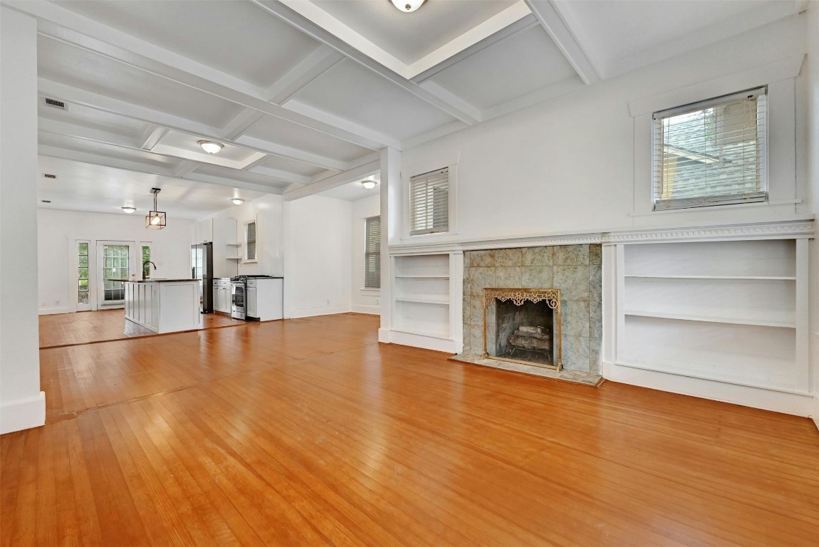 a view of empty room with a fireplace and window