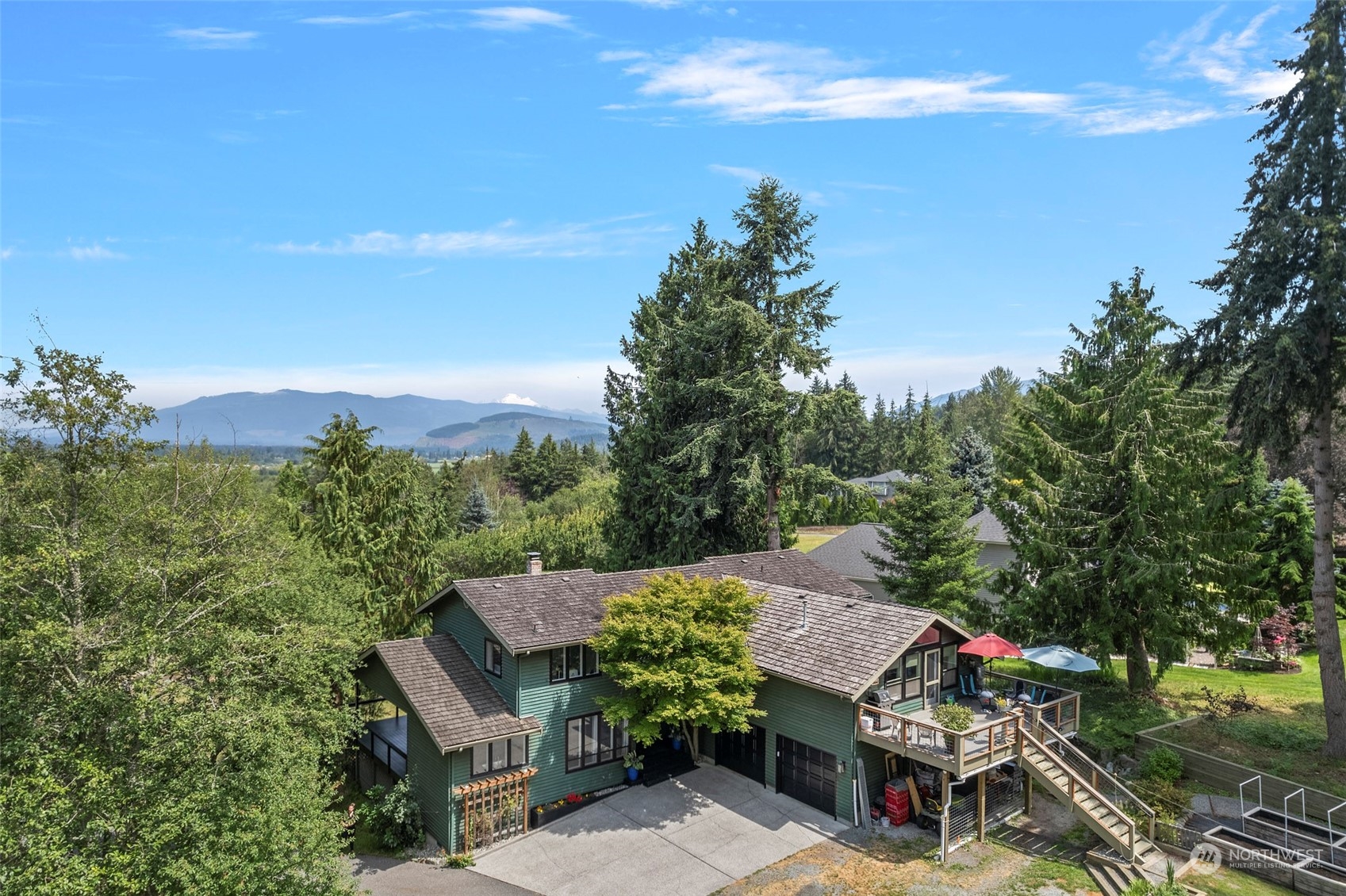 an aerial view of a house with a yard basket ball court and outdoor seating