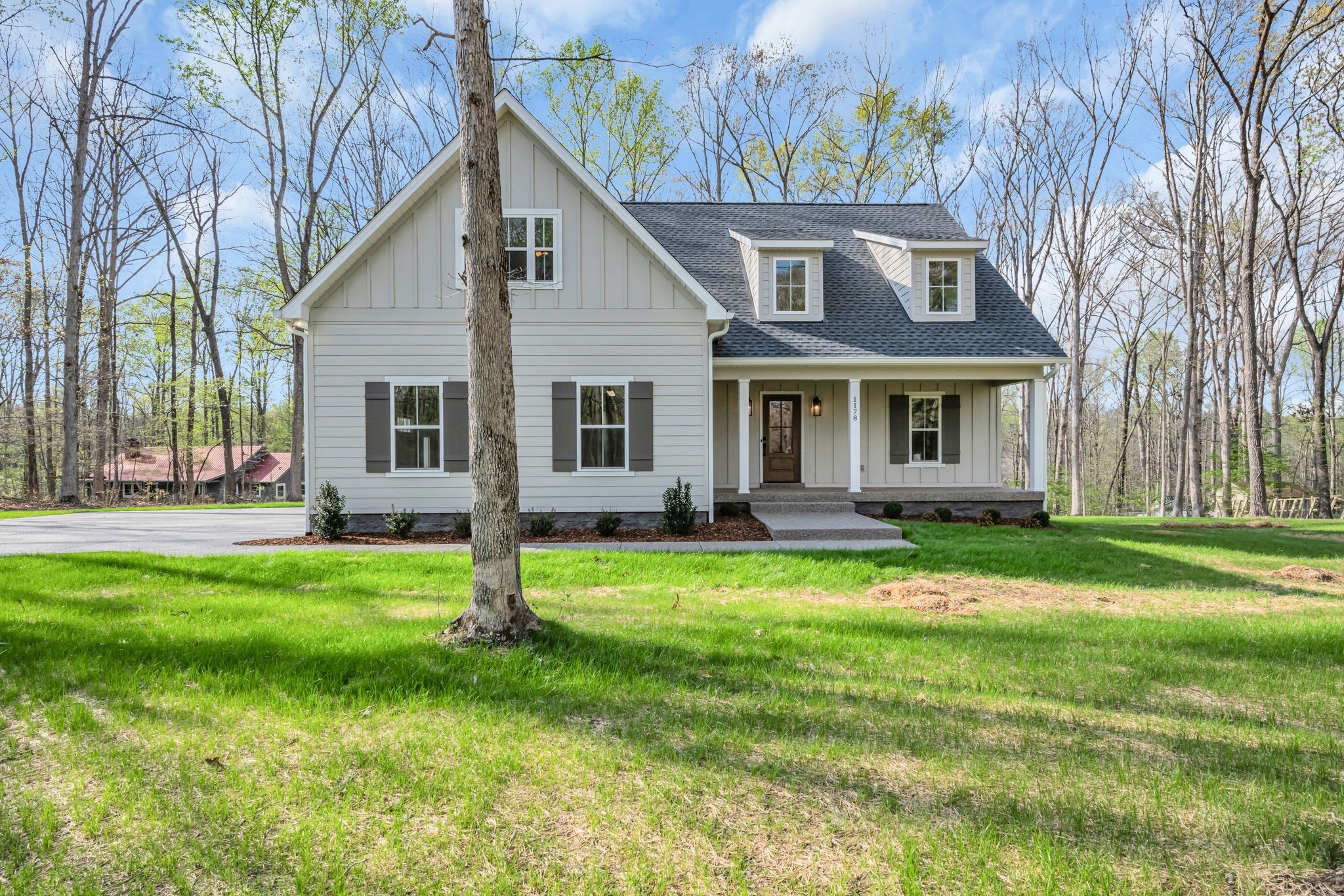 a view of a house with backyard and a tree