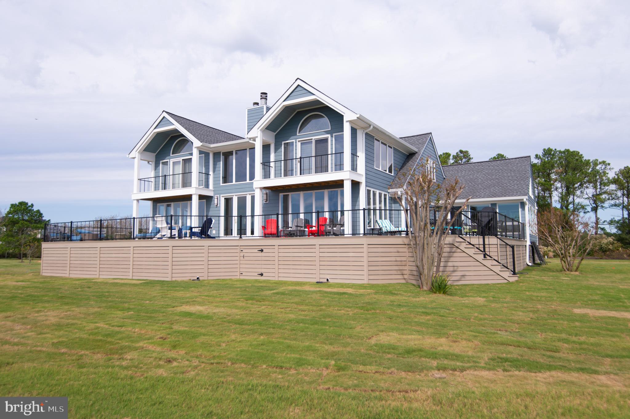 a front view of a house with a yard table and chairs