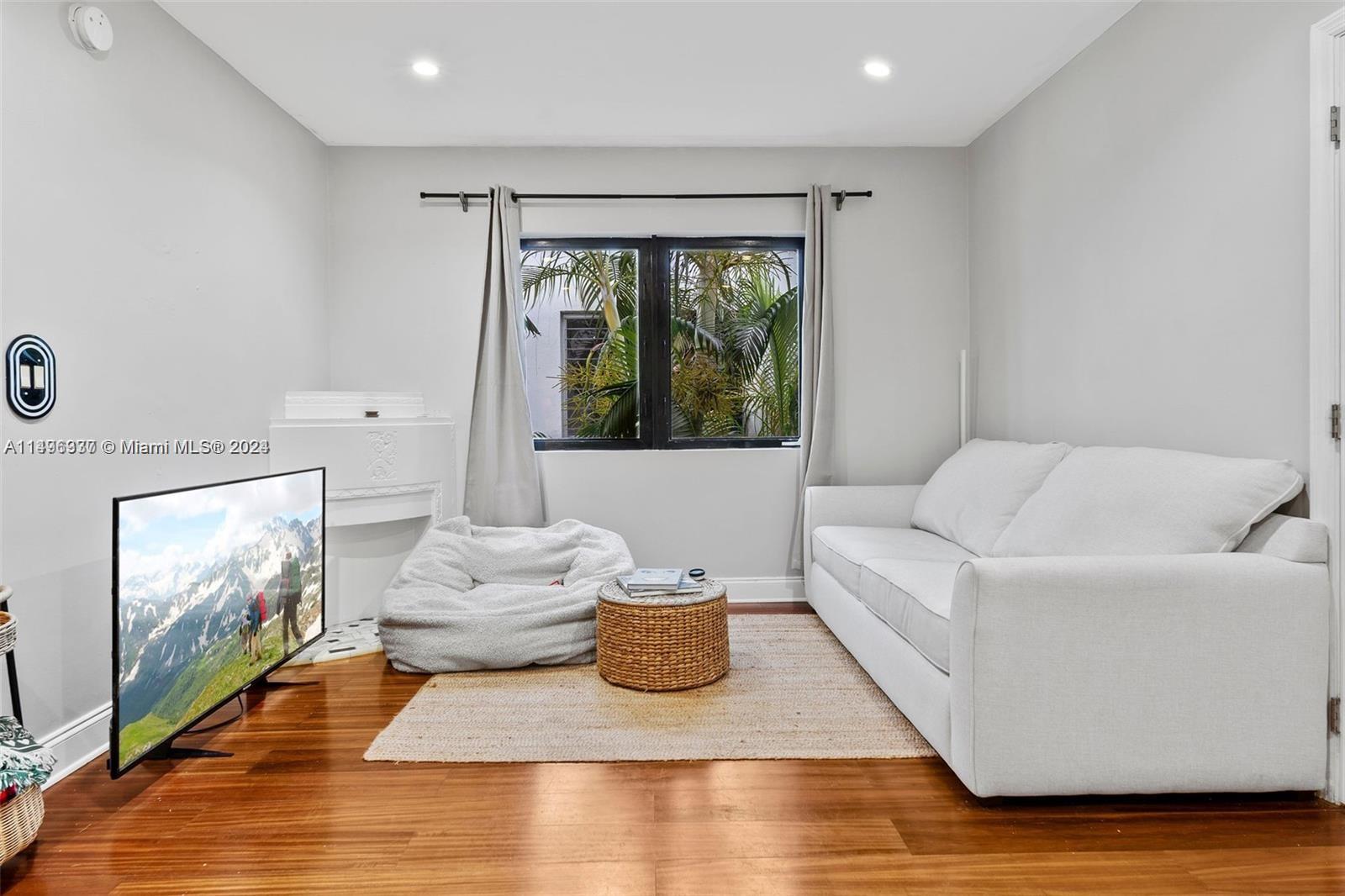 a living room with furniture window and flat screen tv