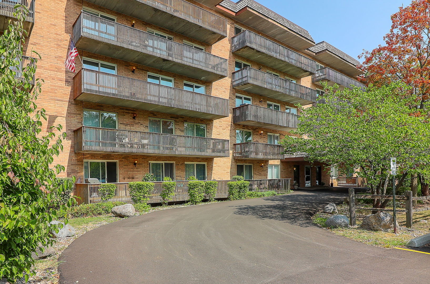 a front view of a building with a garden