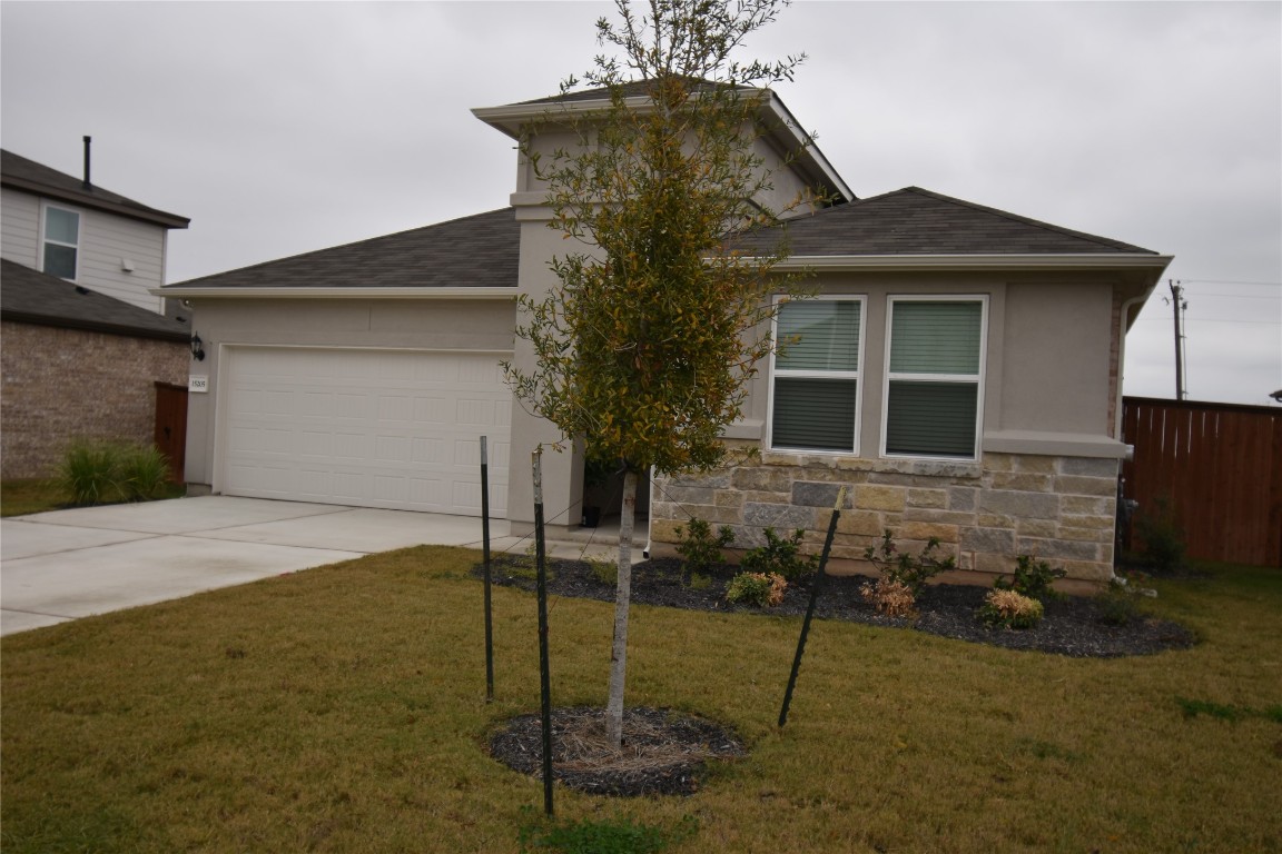 a front view of a house with garden