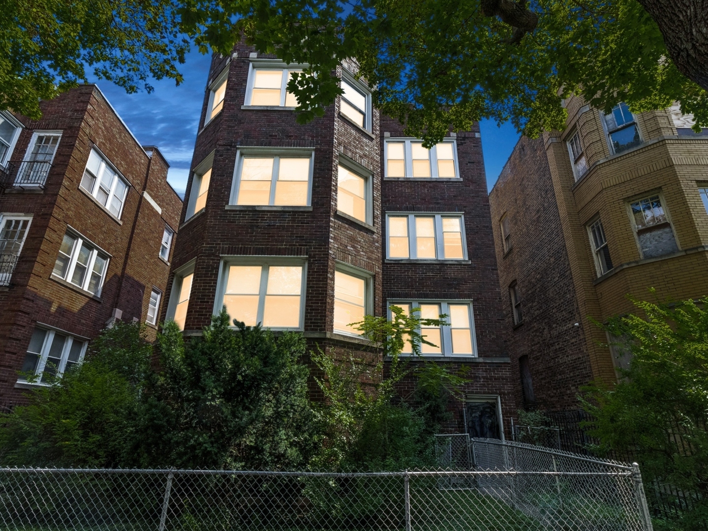 a view of a brick house with a small yard