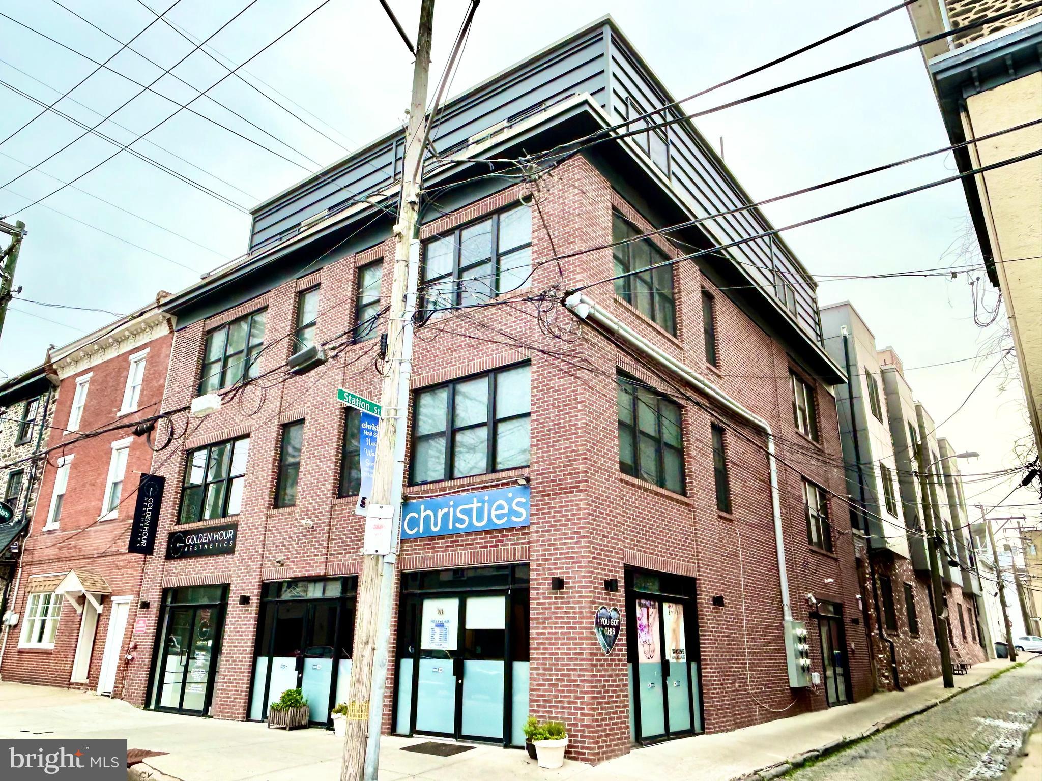 a front view of a residential apartment building with a street