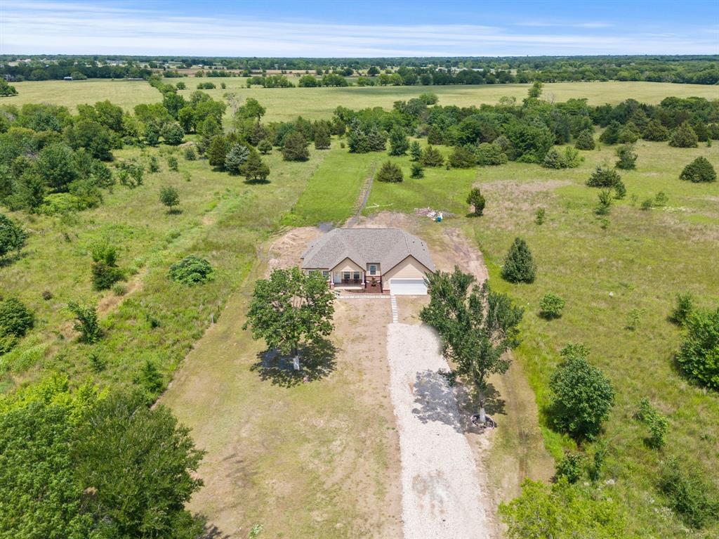 an aerial view of a houses with yard