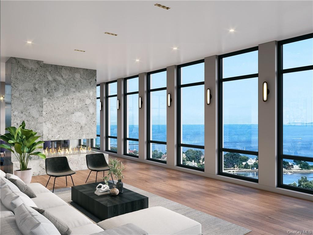 Living room with a water view and light wood-type flooring