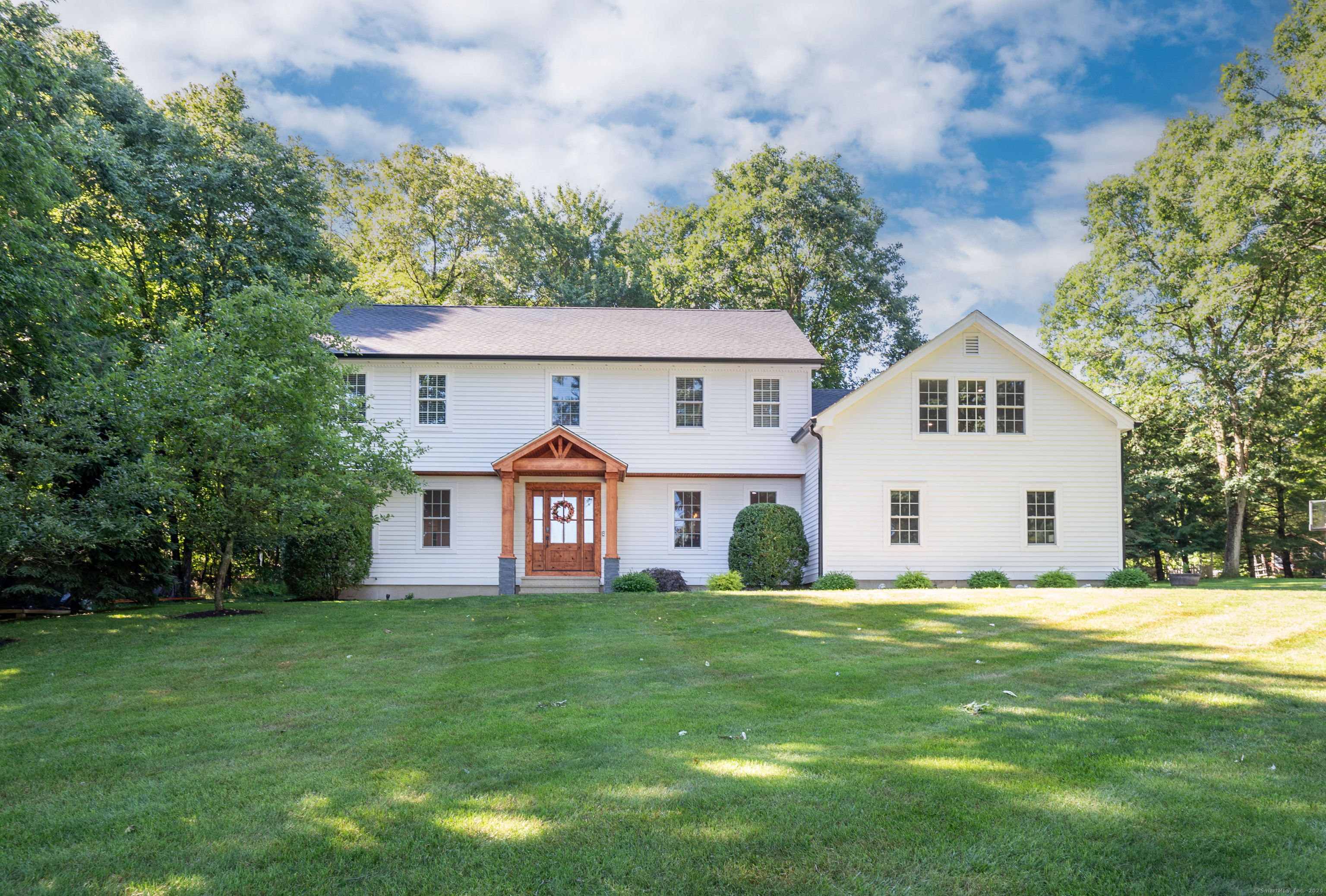 a front view of house with yard and green space