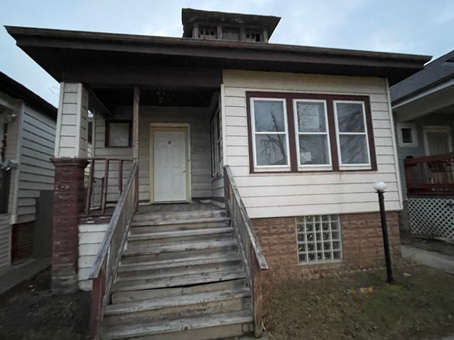 a view of a house with wooden door and furniture