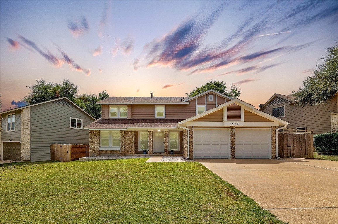 a front view of a house with a yard and garage